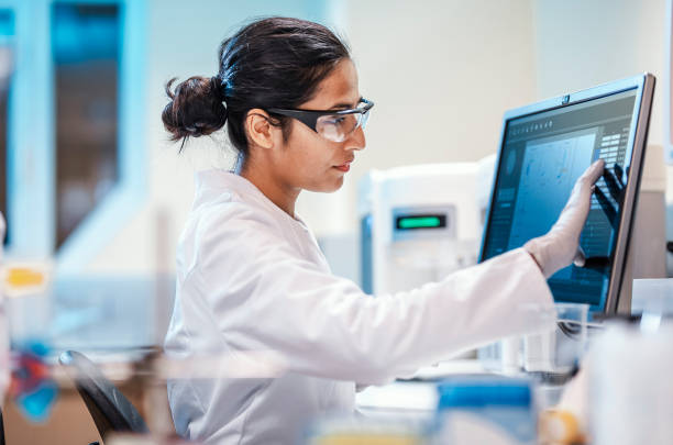 female scientist working in the lab, using computer