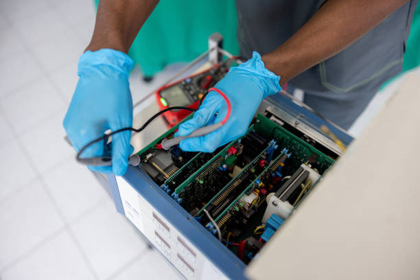 close up on an electrician fixing medical equipment at the hospital